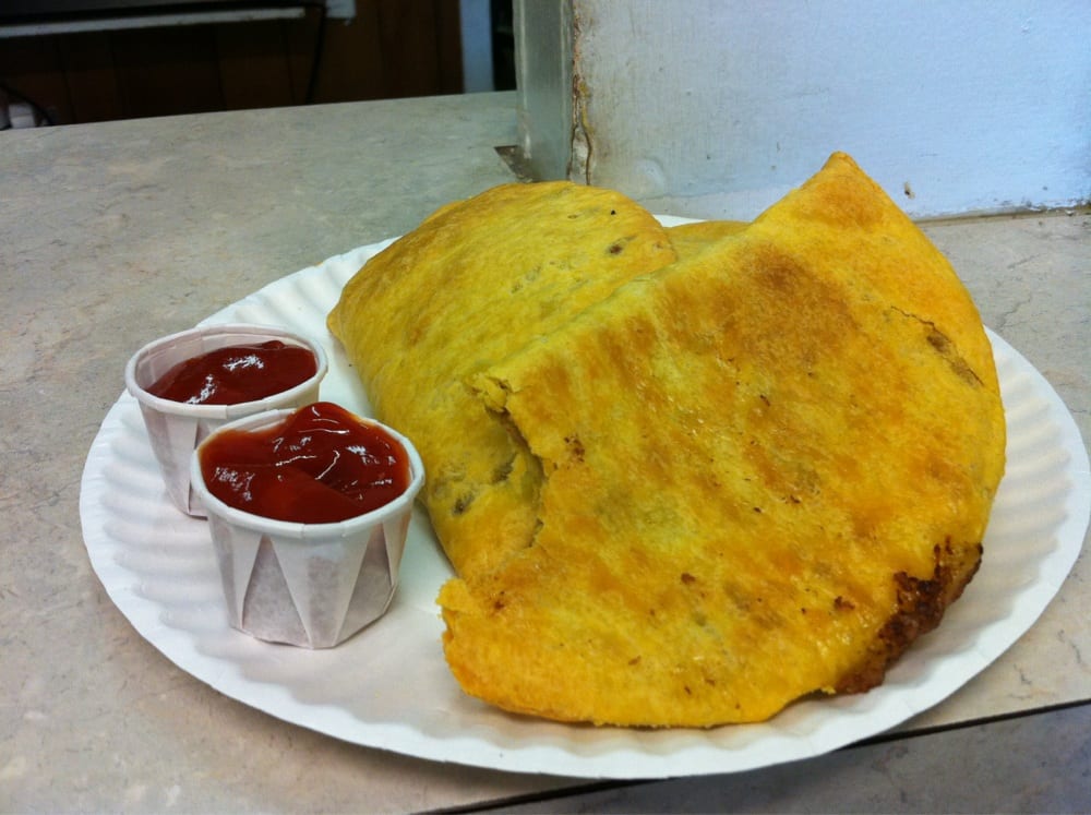 Golden Jamaican beef patties with hot sauce